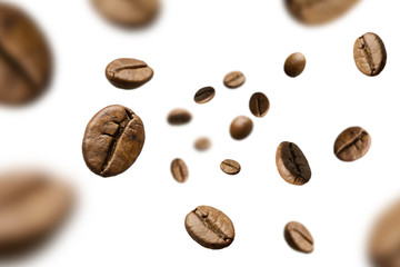 Brown roasted coffee beans falling and flying on black background.Represent breakfast for energy and freshness concept.