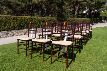 Rows of chairs for guests at an open-air wedding ceremony.