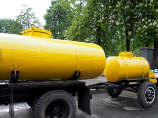 two yellow barrels of the tank on wheels