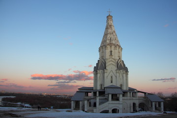 Russian Voznesenskaya church in Moscow museum-reserve Kolomenskoye Park on a winter evening on snow and blue sky background