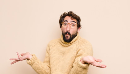 young cool man looking puzzled, confused and stressed, wondering between different options, feeling...