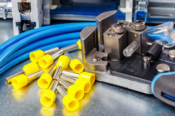 Equipment for wiring close-up. Unused yellow cord end insulated ferrules with wire stripper and...