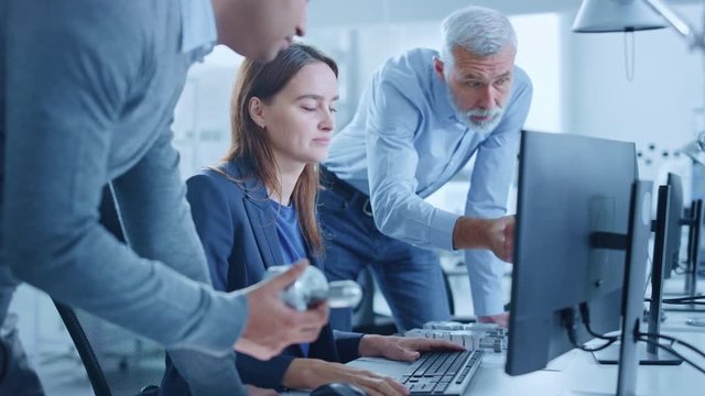 Modern Factory Office: Project Manager and Supervisor Talk to a Female Engineer Works on Computer