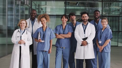 Portrait Of Medical Team Standing In Modern Hospital Building - Powered by Adobe