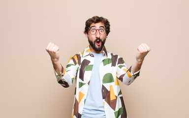 young cool bearded man expressing a concept against flat wall