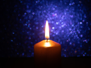 golden candle with bright blue background