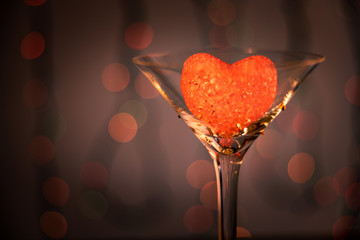 Valentine's day, romantic still life with glass and heart, blurred background, bokeh effect,...