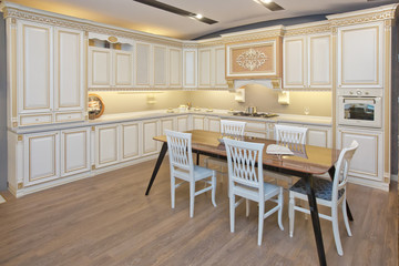 Furniture of the classic italian kitchen. Modern style. Design background. Home decoration. Modern home interior. Modern kitchen design in a light interior. Wood cupboard. Italian kitchen furniture .