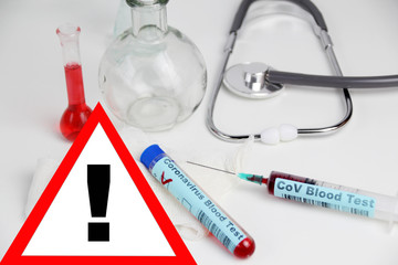 medical laboratory test tube with the word coronavirus test and syringe with blood inside,...