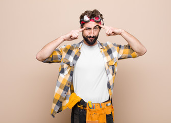 young housekeeper man with a serious and concentrated look, brainstorming and thinking about a...