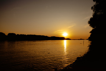 Fototapeta na wymiar Beautiful romantic sunset on a river