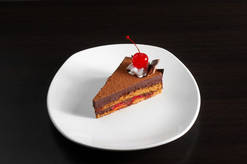 A piece of cake with a red cherry