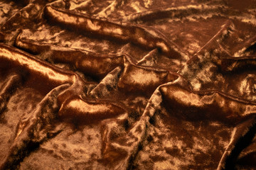 Golden velvet cloth texture background. Top view.