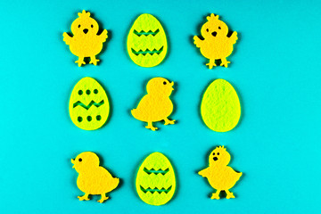 Naklejka premium Easter chickens and eggs on a blue background.