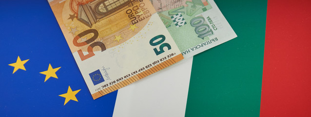 Bulgarian and European Union banknotes in front of EU and Bulgarian flag