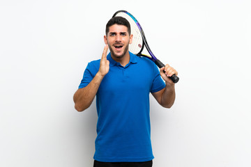 Handsome young tennis player man over isolated white wall with surprise and shocked facial expression