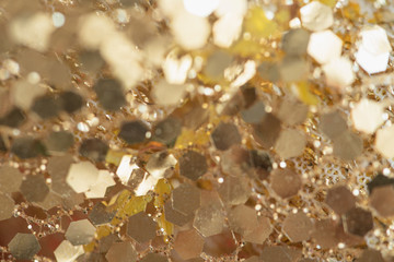 Abstract gold background with copy space. Golden holiday glowing abstract glitter defocused background.