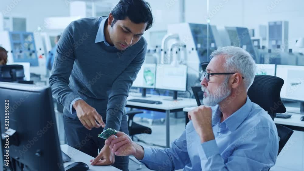 Poster modern factory office: indian project manager talks to caucasian senior engineer who working on comp