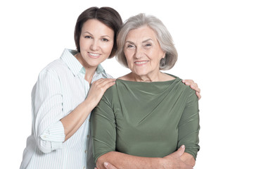 Mother and her adult daughter hugging isolated on white