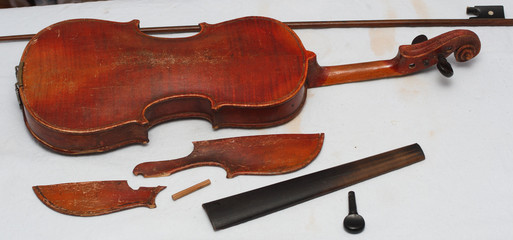 Broken antique red violin for restoration with damage © Mikalai