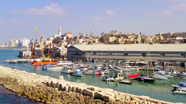 Tel Aviv and Jaffa skyline, aerial view above the old city and port of Jaffa with modern TLV coastline in the distance.