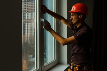 Carpenter repairing window frames, home is being updated to be sold