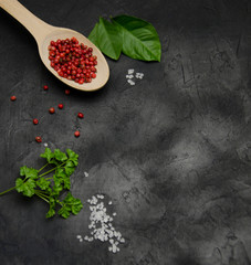 background for recording recipes large salt spices red pepper the leaves of parsley on a black background blurred
