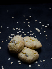 oatmeal cookies with dry oatmeal on a black background blurred image