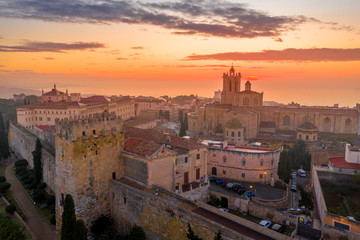Aerial sunrise view of the medieval walled center of Tarragona in Catalunya Spain with the cathedral, city walls, bastions and towers - obrazy, fototapety, plakaty
