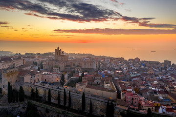 Aerial sunrise view of the medieval walled center of Tarragona in Catalunya Spain with the cathedral, city walls, bastions and towers - obrazy, fototapety, plakaty