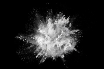 White powder explosion on black background. Colored cloud. Colorful dust explode. Paint Holi.