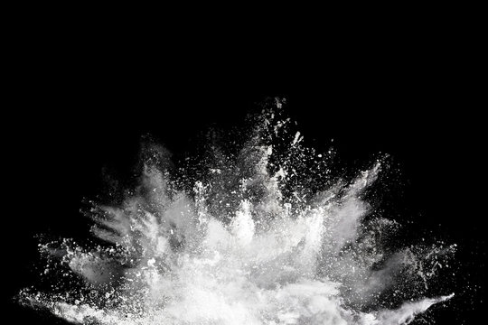 White powder explosion on black background. Colored cloud. Colorful dust explode. Paint Holi.