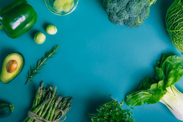 Top view healthy raw vegetables frame with copy space on the blue Turquoise background. Vegetarian and vegan diet. Veganism concept. Sustainable lifestyle, good, real plant-based foods.