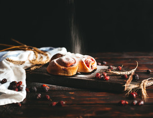 Sweet pastry removed from the oven with strawberry jam and pressed with sugar powder on an old...