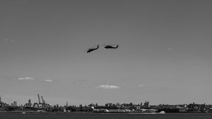 Two helicopters flying around New York City  - Powered by Adobe