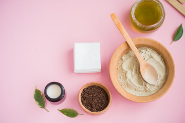 Cosmetic bath salt, grape gomaj for the face, coffee scrub for the body on a pink background.