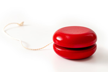 Childhood memories, nostalgia and vintage wood toy concept with red retro wooden yoyo isolated on...