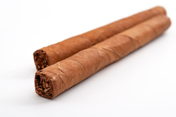 Masculine or macho lifestyle and tobacco smoking concept with two hand rolled cigars isolated on white background