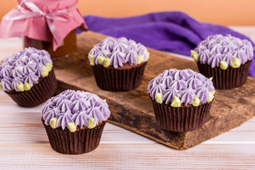 Chocolate cupcakes on a wooden table with salted caramel inside. Dessert.