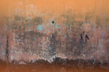 The backdrop of the old cement wall with faded colors, hot tones 