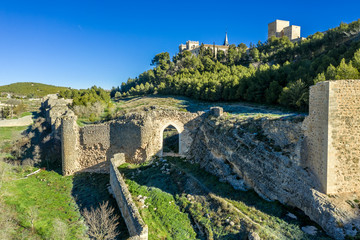 Aerial sunny afternoon view of Ucles castle and monastery historic medieval walled town in Cuenca province Spain