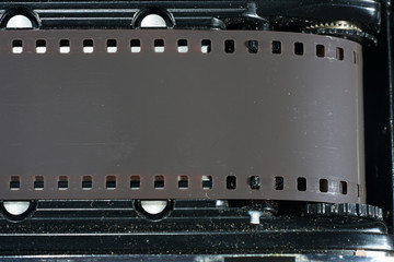 Film transport photographed on an old photo camera in the studio with flash light