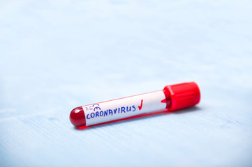 Positive virus Coronavirus blood test on blue copy space background for a banner