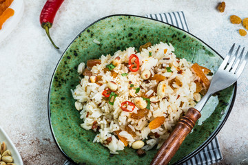 Indian food biryani rice and curry. ramadan food. basmati rice. indian food concept. arabian cuisine. peanut and chili pepper. raisins, dried apricots