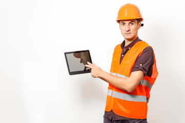 Construction specialist using a tablet computer. At a construction site.