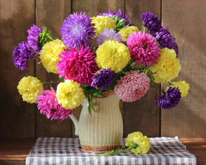 autumn bouquet with asters in a jug.