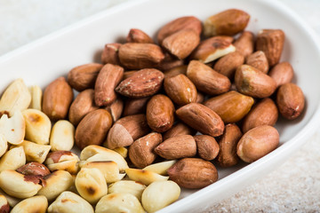 Peanuts in a white cup an old wooden floor. ramadan food. healthy nutrition. healthy food. vegetarian snack