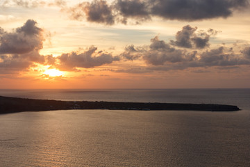 Beautiful sunset on the sea, the sun highlights the clouds