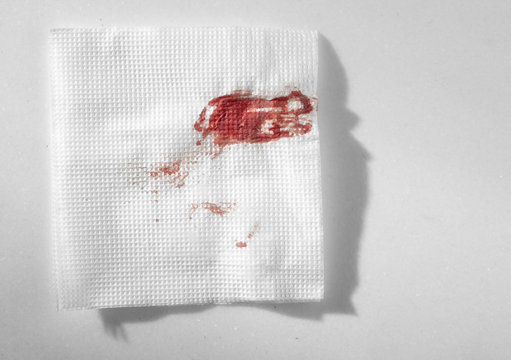 Kitchen paper napkin in the blood. Stopping blood by improvised means.