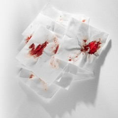 Fototapeta na wymiar Kitchen paper napkin in the blood. Stopping blood by improvised means.